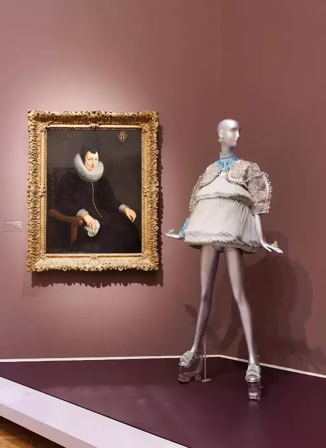 Image of mannequin next to painting
